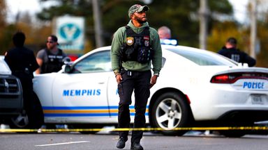 A Memphis Police officer surveys the crime scene following the shooting